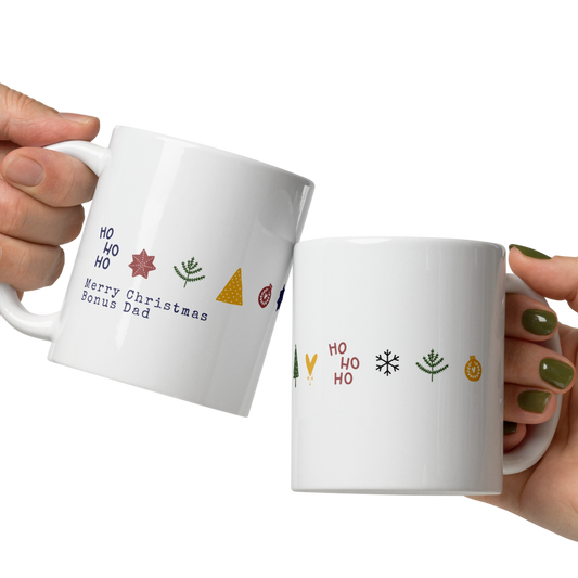 Two hands holding white mugs with colorful designs on a white background