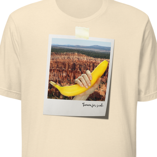 Beige t-shirt with a graphic of a hand holding a banana and text on a white background