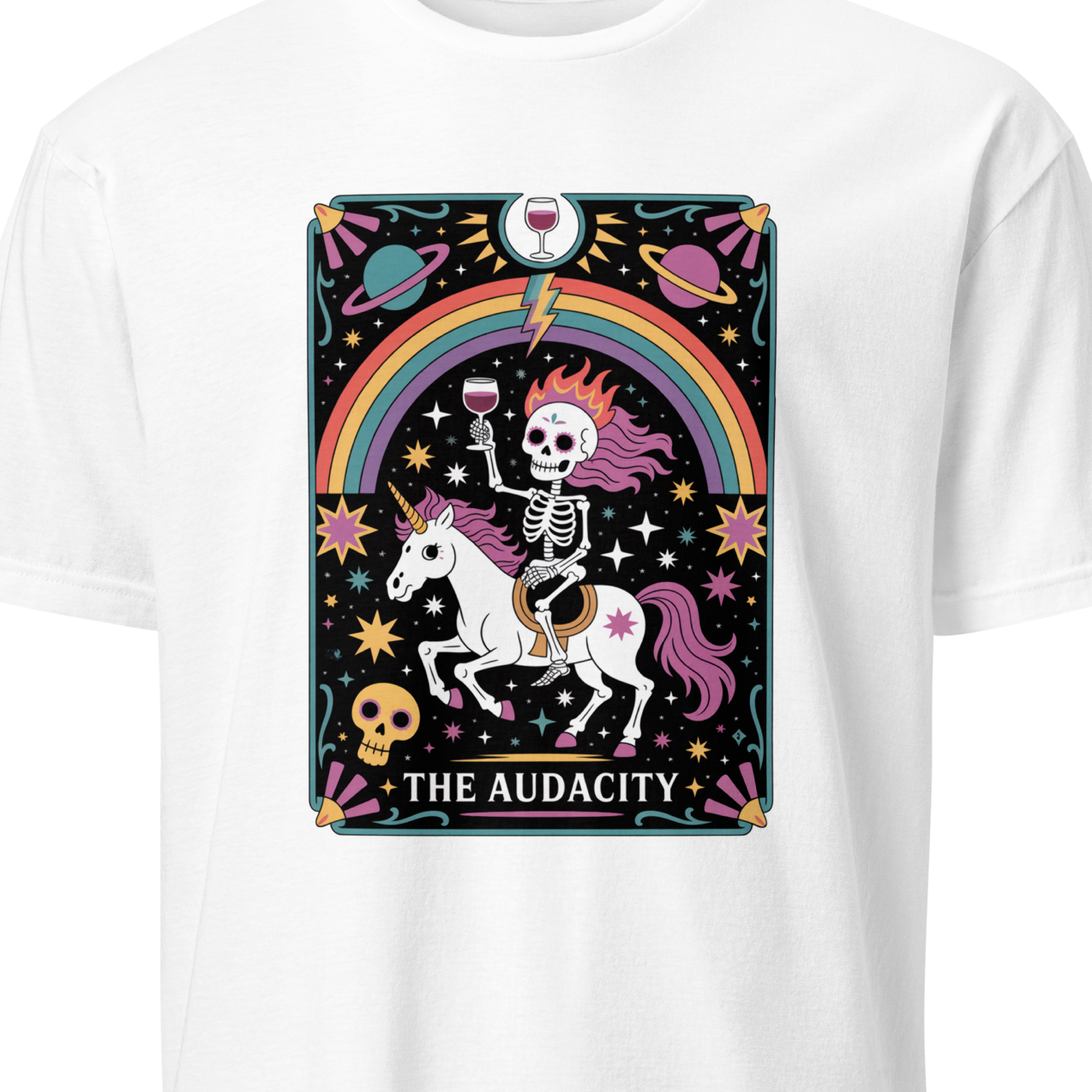 White t-shirt with a colorful graphic of a skeleton on a unicorn with a rainbow, featuring the text 'The Audacity'.