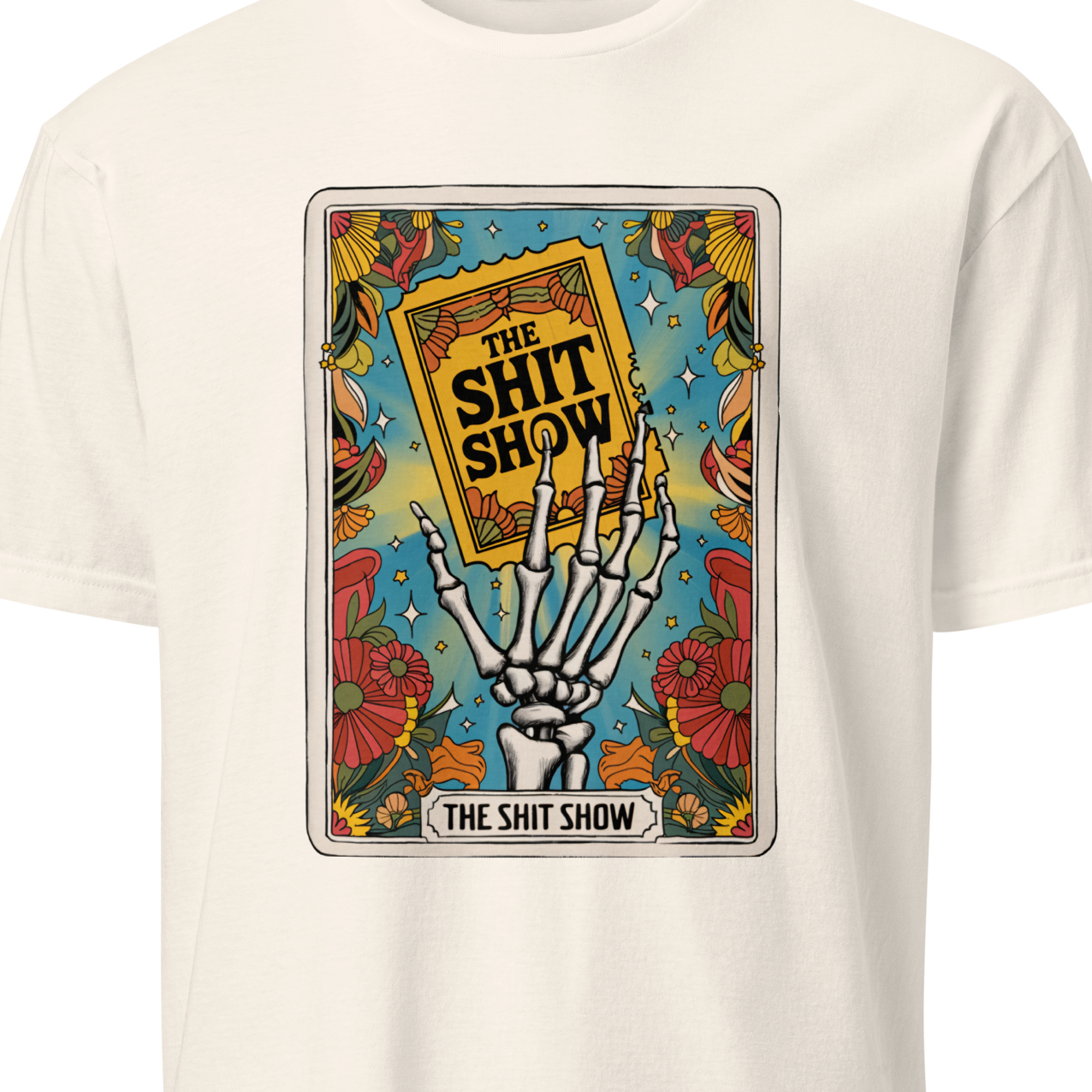 White t-shirt with a graphic design featuring a skeleton hand holding a book titled 'The Shit Show'