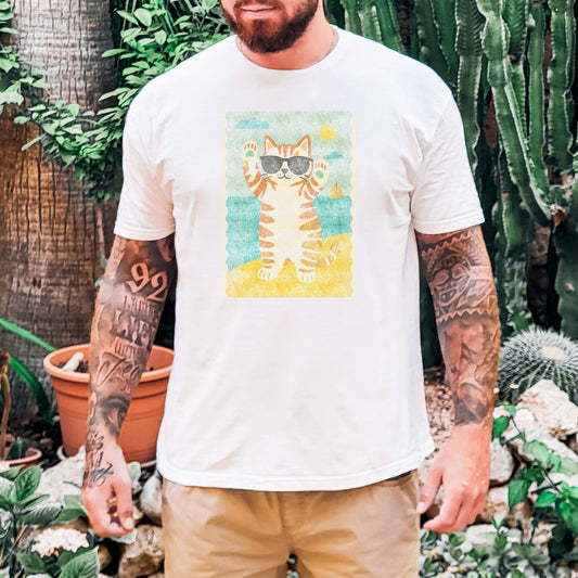 Man wearing a white t-shirt with a cat graphic in a garden setting