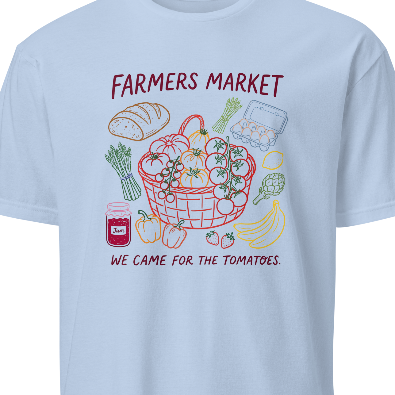 Light blue t-shirt with a colorful graphic of a farmers market and text 