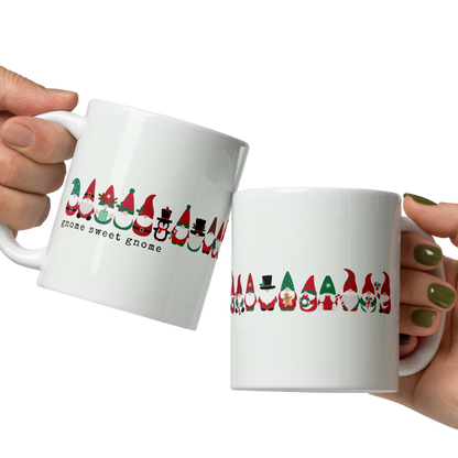 Two hands holding white mugs with colorful designs on a white background