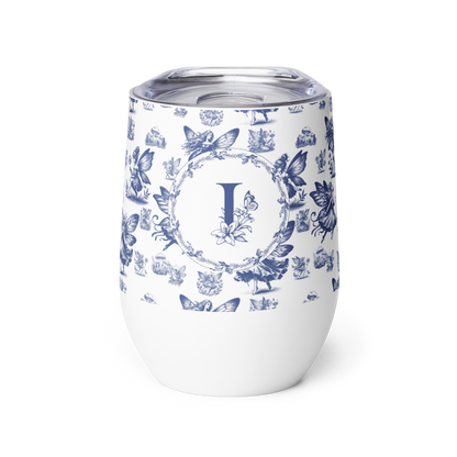 White tumbler with blue floral and butterfly pattern and letter 'I' on a white background