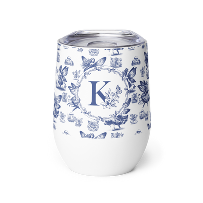 White tumbler with blue floral pattern and letter 'K' on a white background