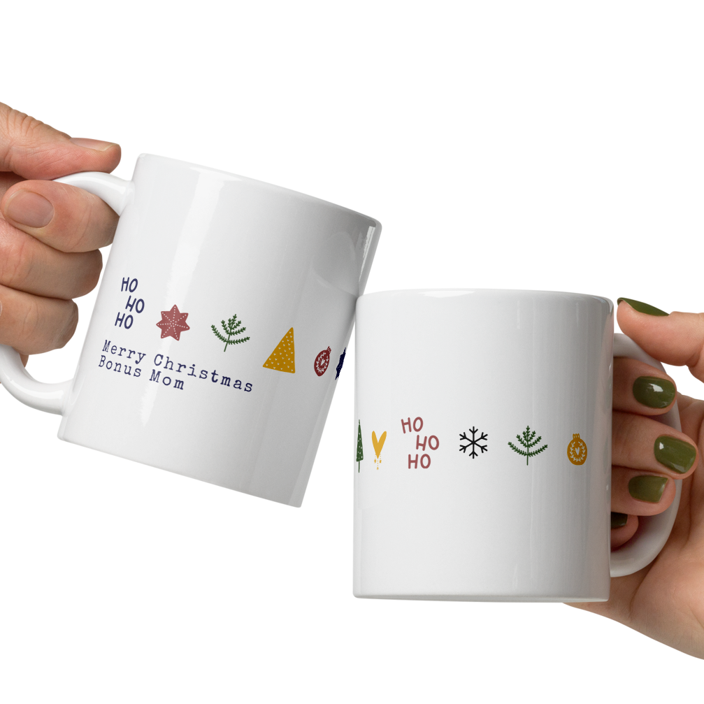 Two hands holding white mugs with Christmas-themed designs on a white background
