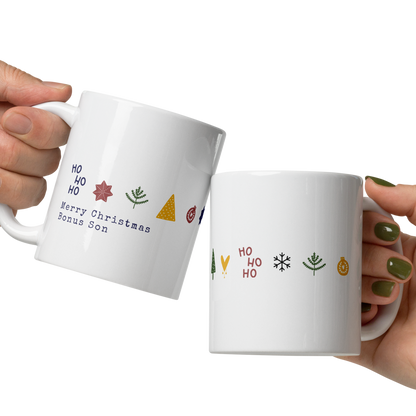 Two hands holding white mugs with colorful designs on a white background
