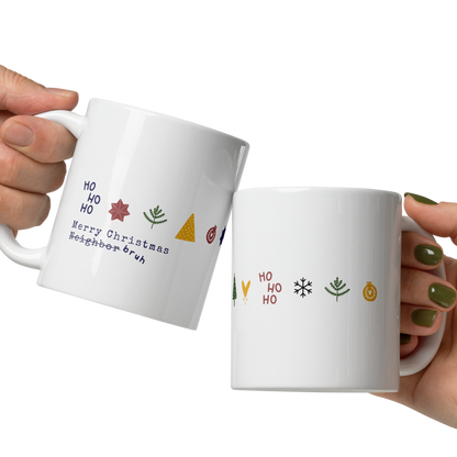 Two hands holding white mugs with Christmas-themed designs on a white background