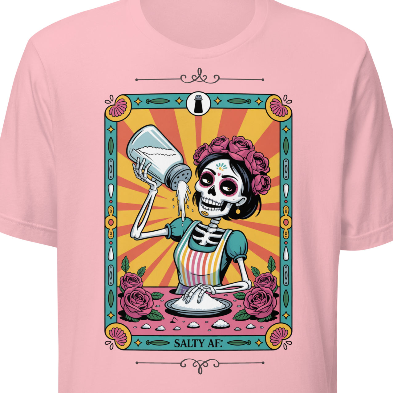 Pink t-shirt with a colorful graphic of a skeleton holding a salt shaker, surrounded by roses.