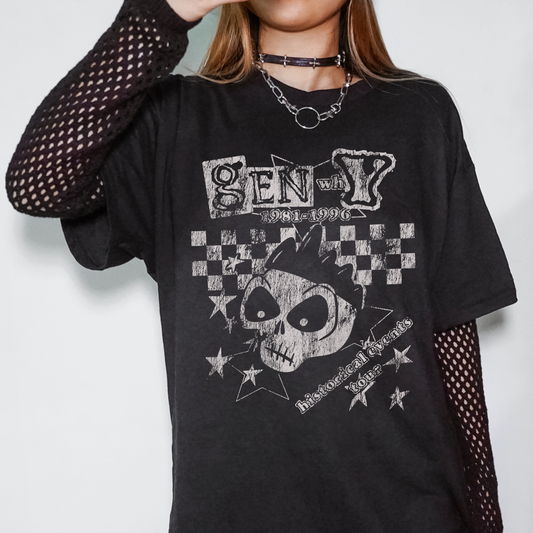 Person wearing a black t-shirt with a graphic design on a plain background
