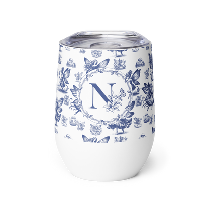 White tumbler with blue floral design and letter 'N' on a white background