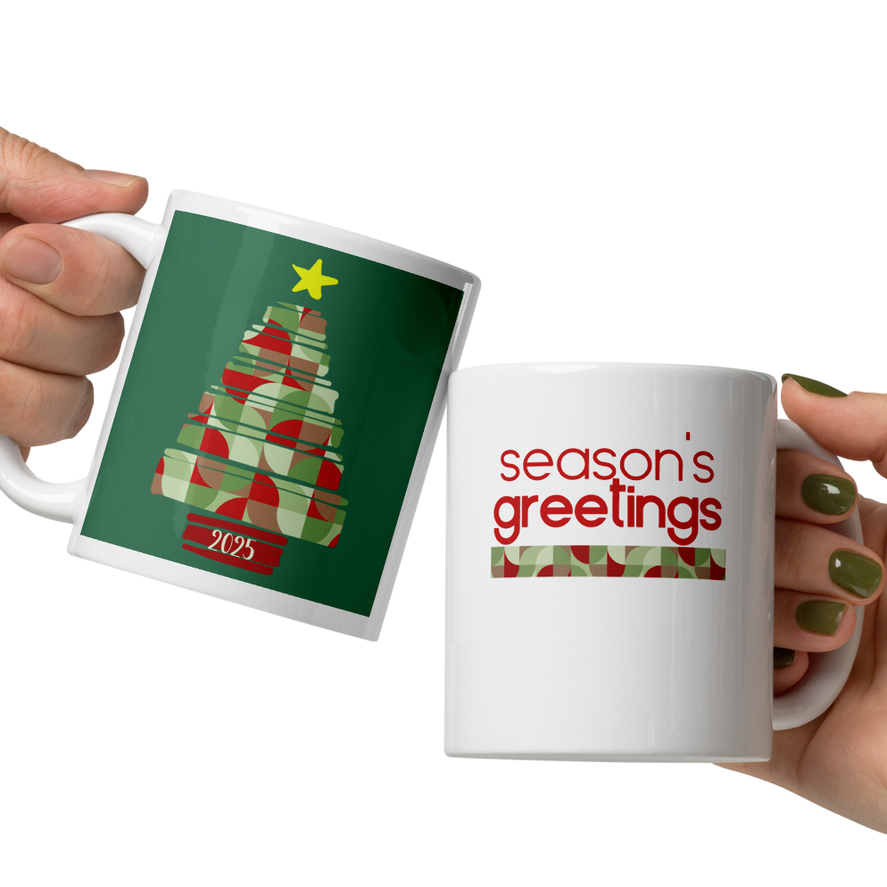 Two hands holding Christmas-themed mugs with tree and 'season's greetings' designs.