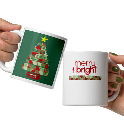 Two hands holding Christmas-themed mugs with tree and 'merry bright' designs.