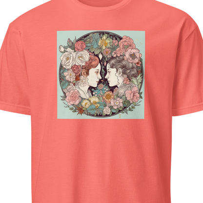 Coral t-shirt with a graphic of two faces surrounded by flowers on a white background