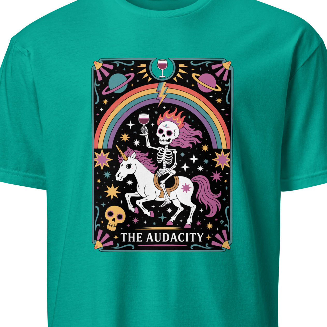 Teal t-shirt with a graphic design featuring a skeleton on a unicorn with a rainbow and stars, labeled 'The Audacity'.