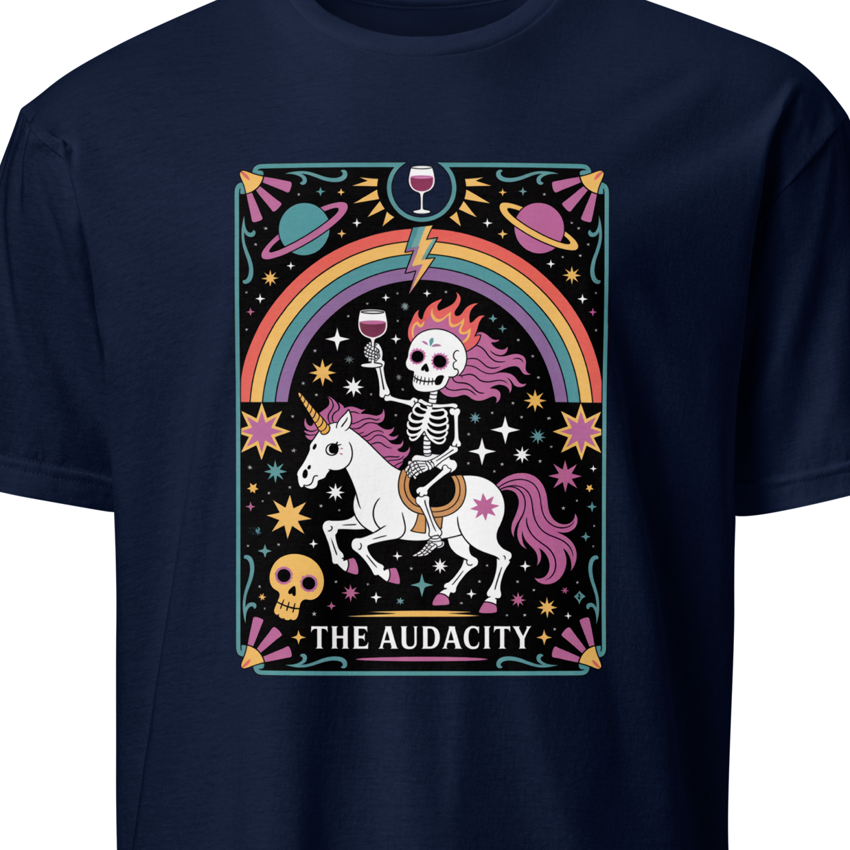 Navy blue t-shirt with a colorful graphic of a skeleton on a unicorn, rainbow, and text 'THE AUDACITY'