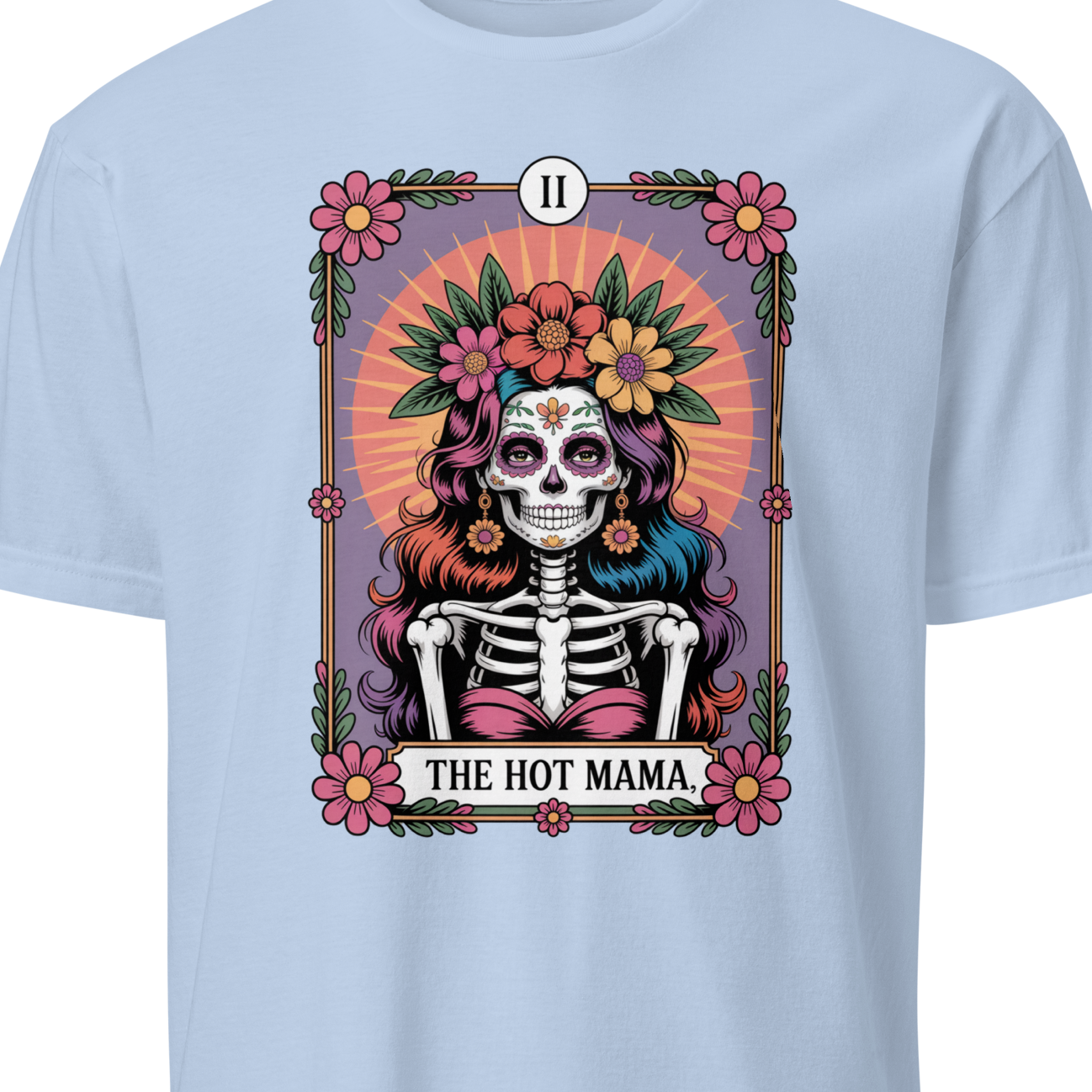Light blue t-shirt with a colorful graphic of a skeleton wearing a floral headpiece and text 'The Hot Mama' 