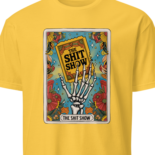 Yellow t-shirt with a graphic design featuring a skeleton hand holding a book titled 'The Shit Show' 