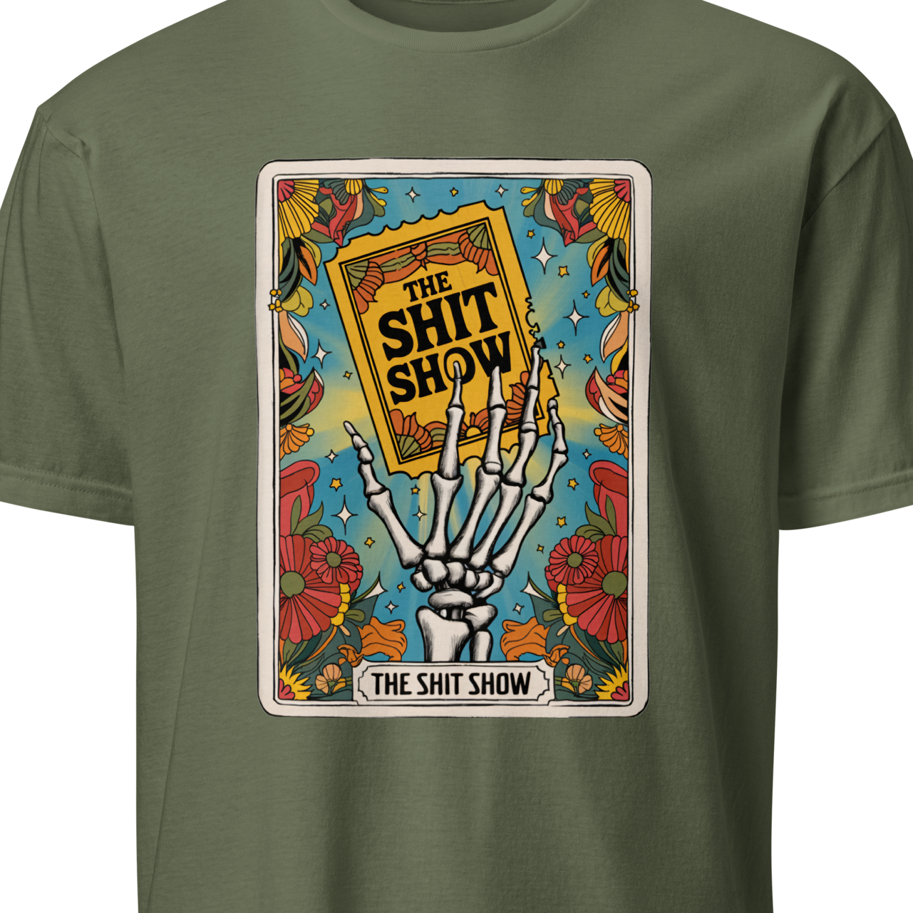 Green t-shirt with a graphic design featuring a skeleton hand holding a book titled 'The Shit Show' 