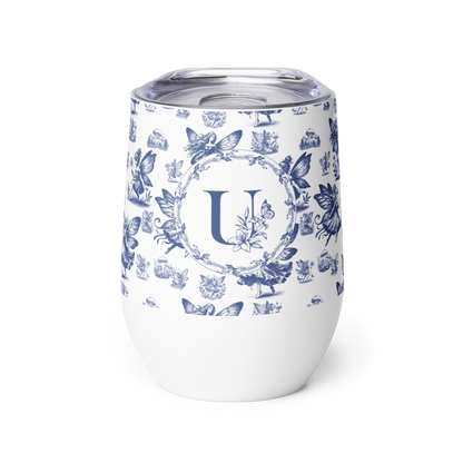 White tumbler with blue floral pattern and letter 'U' on a white background
