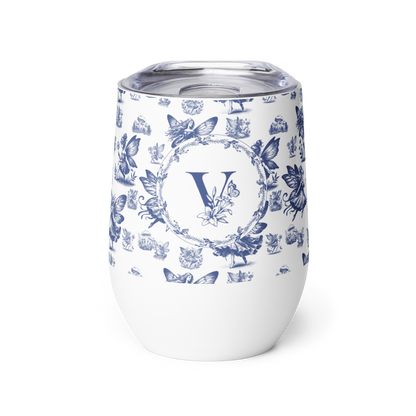 White tumbler with blue floral and butterfly pattern and letter 'V' on a white background