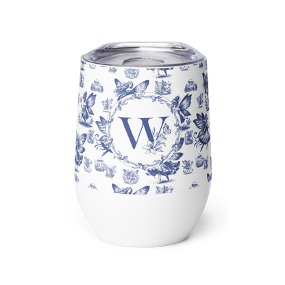 White tumbler with blue floral pattern and letter 'W' on a white background