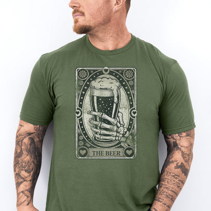 Man wearing a green t-shirt with a graphic design of a hand holding a beer mug and text 'The Beer' on a white background.