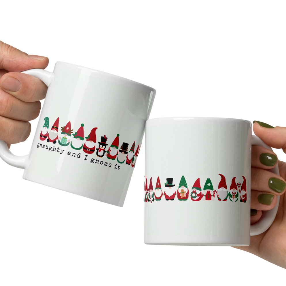 Two hands holding white mugs with Christmas-themed designs on a white background
