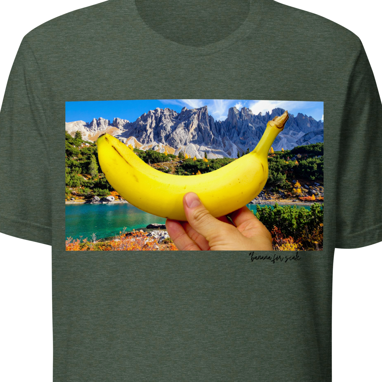 Green t-shirt with a graphic of a hand holding a banana over a scenic landscape.