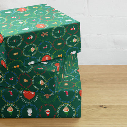 Green wrapping paper with festive designs on a wooden surface